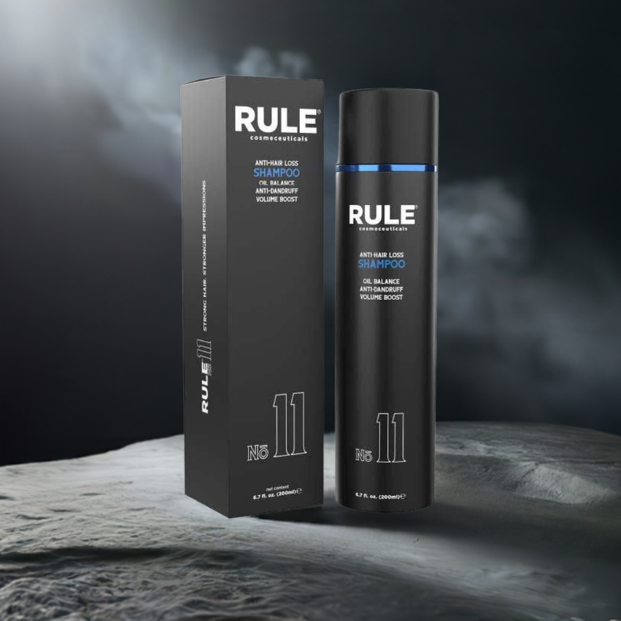 Rule No. 11 Anti-Hair Loss Shampoo packaging and bottle, featuring oil balance, anti-dandruff, and volume boost benefits, displayed on a textured surface with a smoky backdrop, emphasizing its advanced and premium formula.