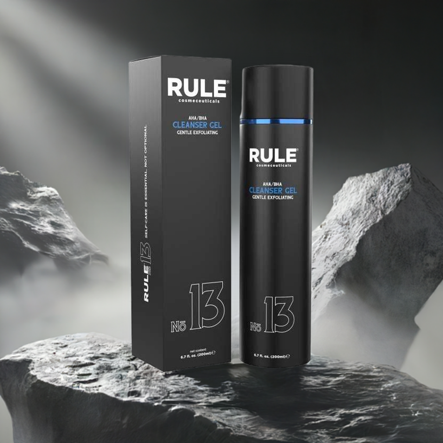 Rule No. 13 AHA/BHA Cleanser Gel packaging and bottle, featuring gentle exfoliation benefits, displayed on rugged stone with a dramatic, illuminated backdrop, emphasizing its premium and performance-driven skincare qualities.