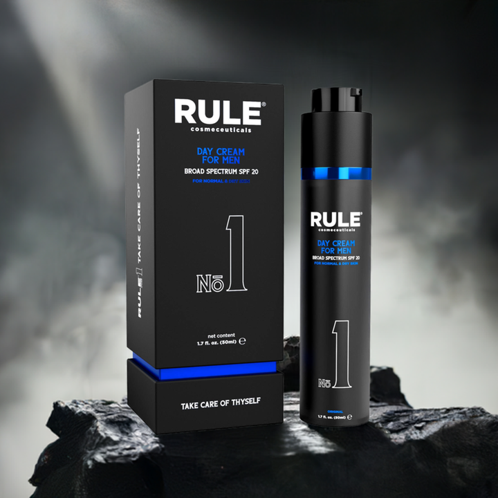 Rule No. 1 All-in-One Day Cream for Men packaging and bottle, featuring SPF 20 protection, displayed on a rugged stone surface with dramatic lighting and a smoky background, emphasizing its bold and premium aesthetic.