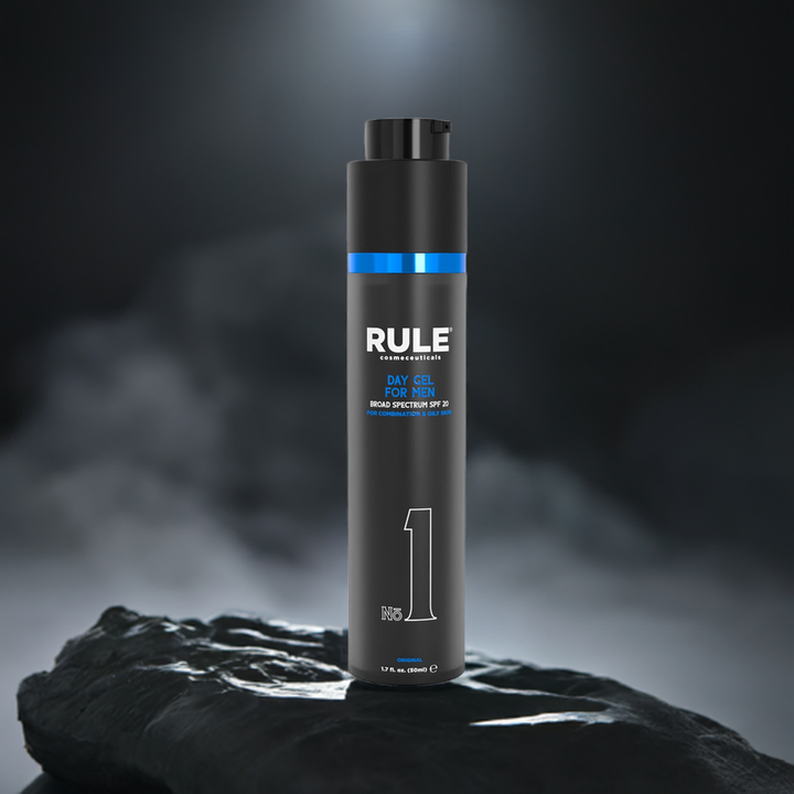 Rule No. 1 Day Gel for Men bottle, featuring SPF 20 protection for combination and oily skin, set on a rugged stone surface under a focused spotlight, with a dramatic smoky background, emphasizing its bold and premium design.