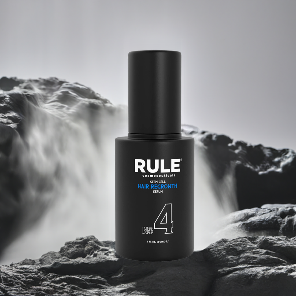 Rule No. 4 Stem Cell Hair Regrowth Serum bottle, emphasizing advanced hair restoration benefits, displayed on rugged stone with a flowing waterfall backdrop, highlighting its natural yet powerful qualities.