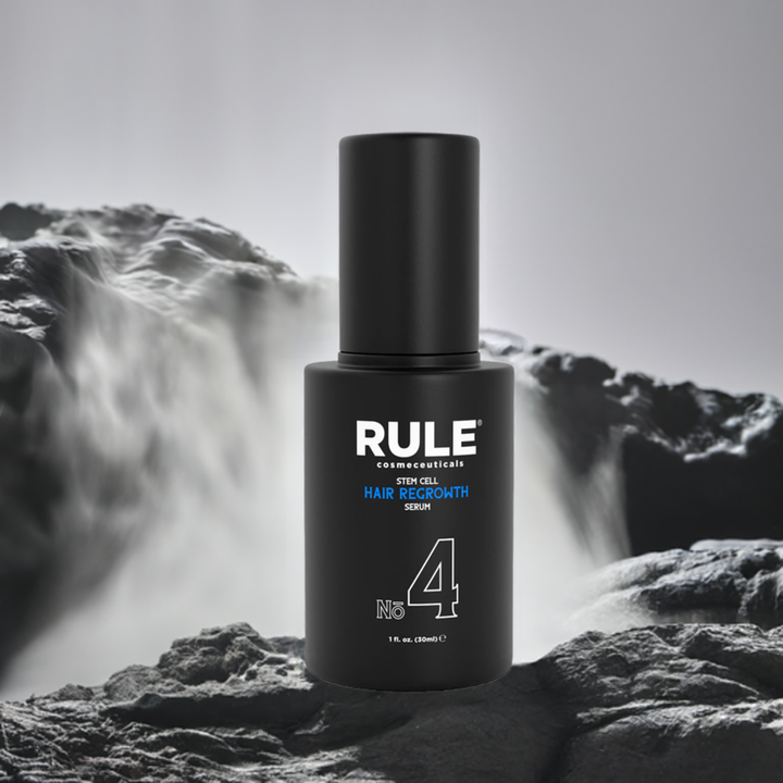 Rule No. 4 Stem Cell Hair Regrowth Serum bottle, emphasizing advanced hair restoration benefits, displayed on rugged stone with a flowing waterfall backdrop, highlighting its natural yet powerful qualities.