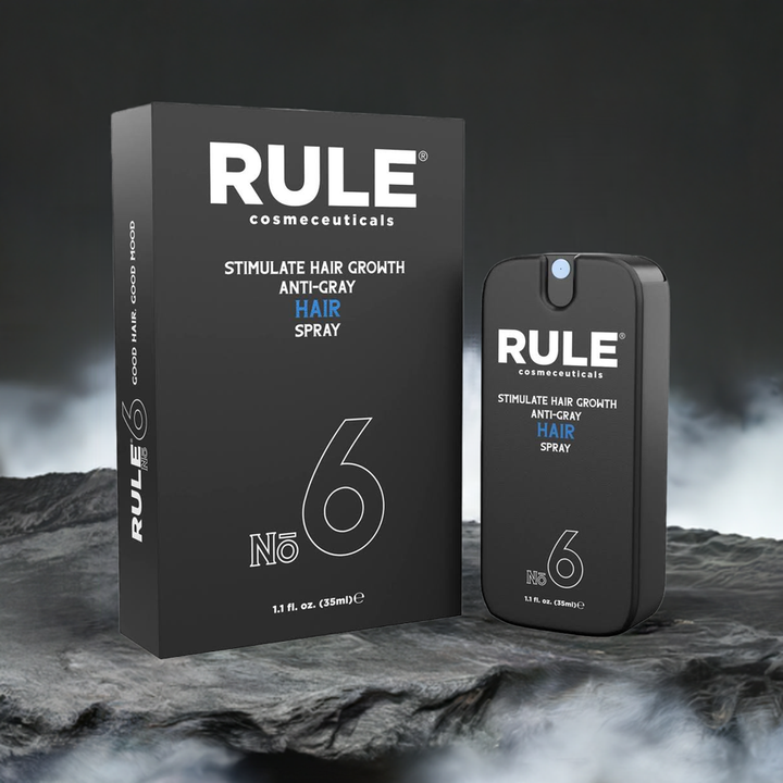 Rule Cosmeceuticals No. 6 Anti-Gray Hair Spray with Stimulate Hair Growth formula, featuring both the bottle and box set against a rugged, dark stone backdrop with a misty atmosphere. A premium product designed for hair rejuvenation and grey reduction.