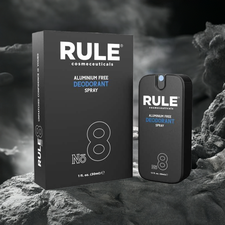 Rule Cosmeceuticals No. 8 Aluminum-Free Deodorant Spray, featuring both the bottle and box, set against a rugged, smoky stone backdrop. A premium deodorant offering long-lasting freshness and confidence without aluminum.